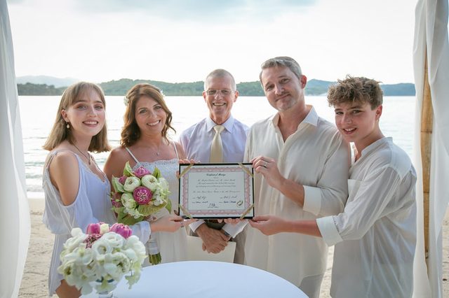 Peter Notley with a newly married couple and family after a Phuket wedding ceremony