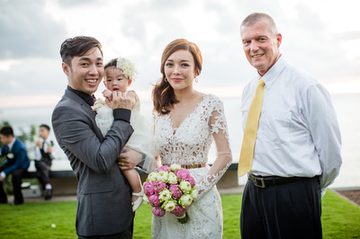 Wedding couple with Peter Notley at an outdoor Phuket ceremony