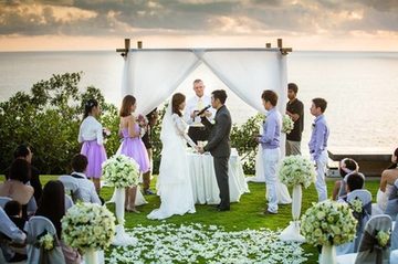 Beach wedding ceremony with guests and a flower-covered aisle in Phuket