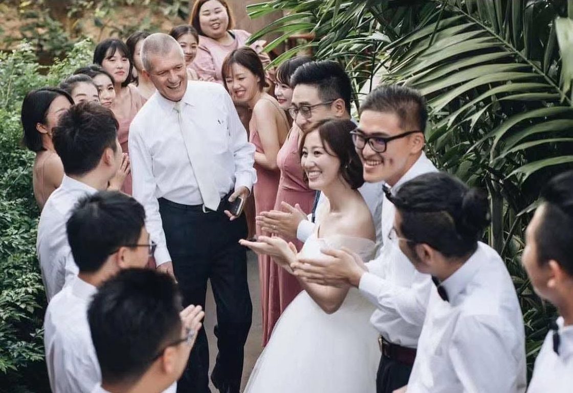 Wedding couple celebrating with guests and Peter Notley after a ceremony in Phuket