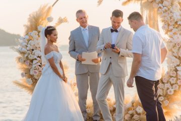 Couple exchanging rings while Peter Notley officiates a Phuket wedding