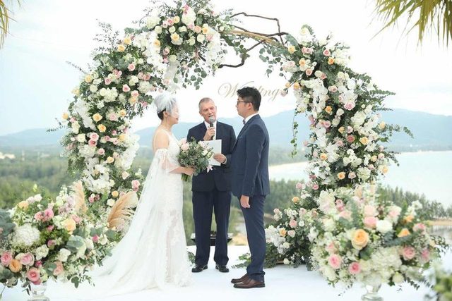 Peter Notley officiating a flower-filled Phuket wedding ceremony
