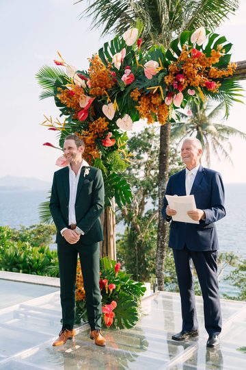 Peter Notley standing with a wedding couple at an outdoor Phuket ceremony
