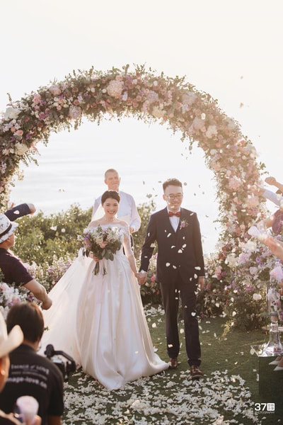 A Phuket wedding ceremony framed by tropical flowers and sea views